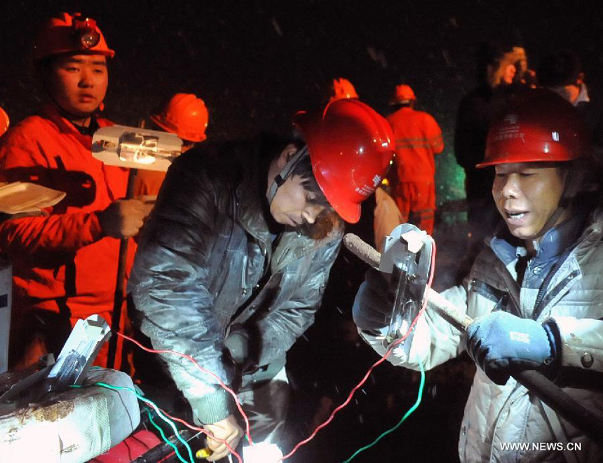 Rescuers work at the mud-inundated debris after a landslide hit Gaopo Village in Zhenxiong County, southwest China&apos;s Yunnan Province, Jan. 11, 2013.