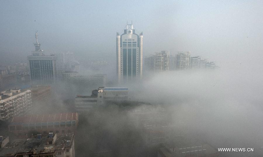 Buildings are seen amid dense fog in Wuhan City, capital of central China&apos;s Hubei Province, Jan. 12, 2013. 