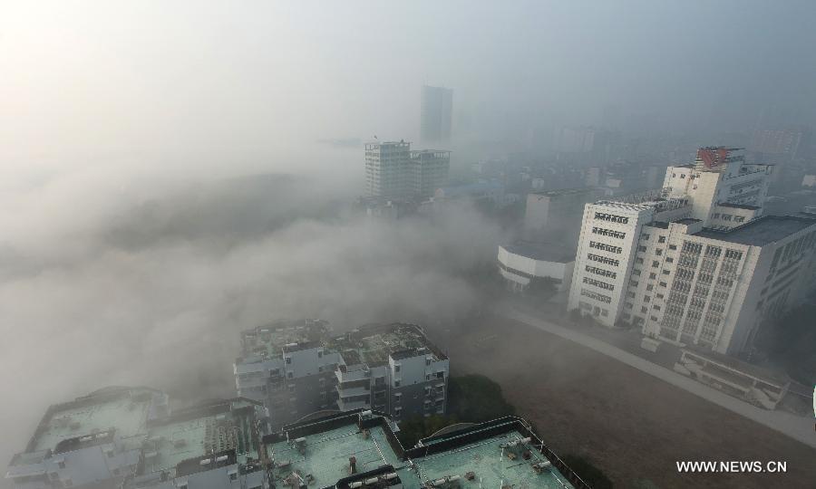 Buildings are seen amid dense fog in Wuhan City, capital of central China&apos;s Hubei Province, Jan. 12, 2013.
