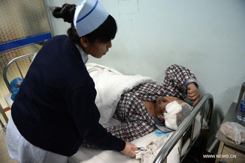 A nurse takes care of a man who got injured in a blast in a hospital in Shuangyashan City, northeast China's Heilongjiang Province, Jan. 11, 2013. 