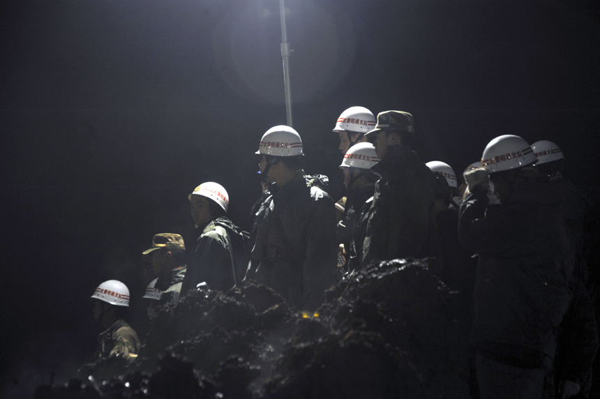 Rescuers work at the mud-inundated debris after a landslide hit Gaopo Village in Zhenxiong County, southwest China&apos;s Yunnan Province, Jan. 12, 2013.