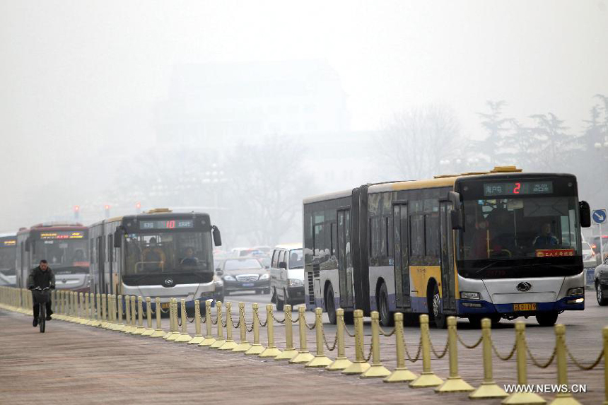 Buses pass by the Tian&apos;anmen Square in Beijing, capital of China, Jan. 11, 2013. The PM 2.5 (particles less than 2.5 microns) data in Beijing hit 240 to 446 on Friday, which means the 6 rating heavily polluted air quality. 
