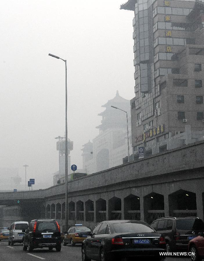 Buildings are wrapped up by haze in Beijing, capital of China, Jan. 11, 2013. The PM 2.5 (particles less than 2.5 microns) data in Beijing hit 240 to 446 on Friday, which means the 6 rating heavily polluted air quality.