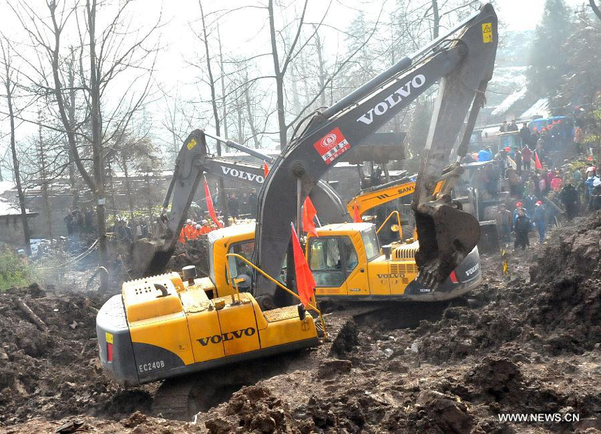 An excavator works at a landslide spot in Zhenxiong mountain of Zhaotong City, southwest China's Yunnan Province, Jan. 12, 2012. The rescue of a landslide which hit the Zhaojiagou area of Gaopo Village early Friday finished after all 46 bodies were retrieved Saturday.