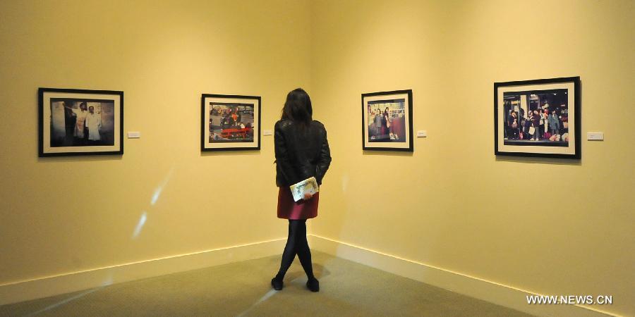 An audience visits the Images of Chinatown photo exhibition at Chinese Culture Center in San Francisco, the United States, Jan. 13, 2013. 