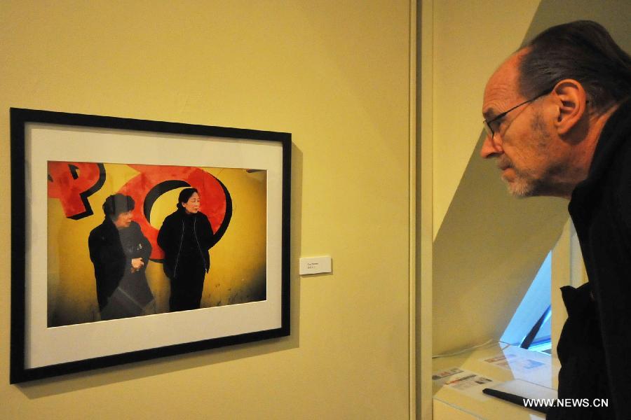 An audience visits the Images of Chinatown photo exhibition at Chinese Culture Center in San Francisco, the United States, Jan. 13, 2013. 