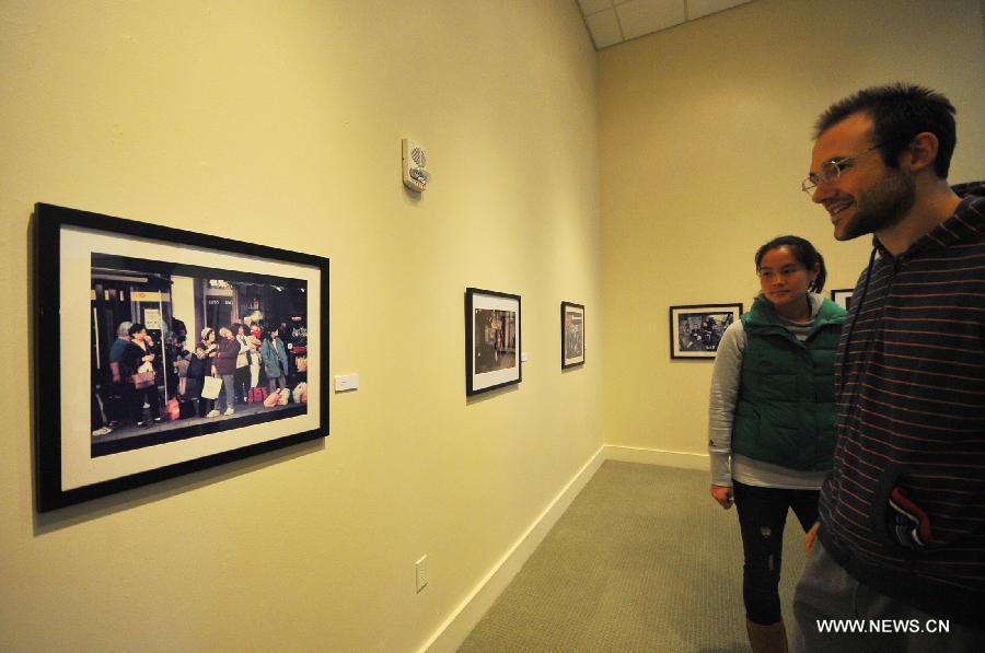 Audience visit the Images of Chinatown photo exhibition at Chinese Culture Center in San Francisco, the United States, Jan. 13, 2013.