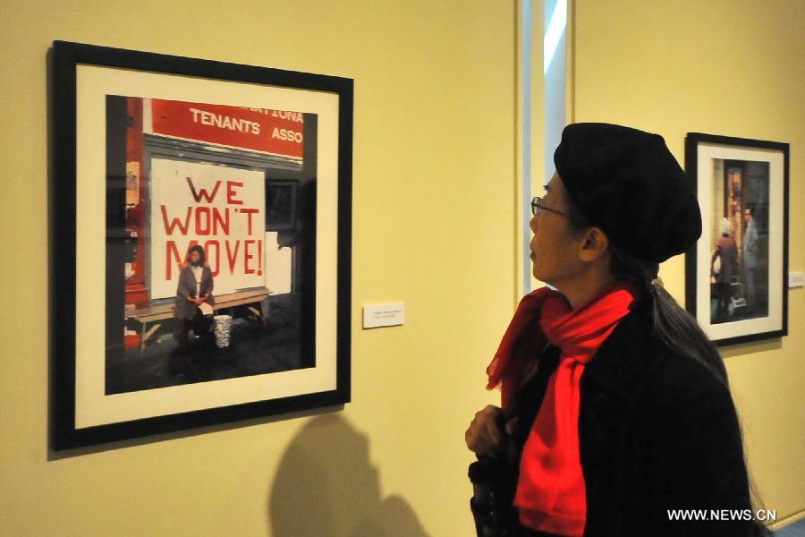 An audience visits the Images of Chinatown photo exhibition at Chinese Culture Center in San Francisco, the United States, Jan. 13, 2013. 