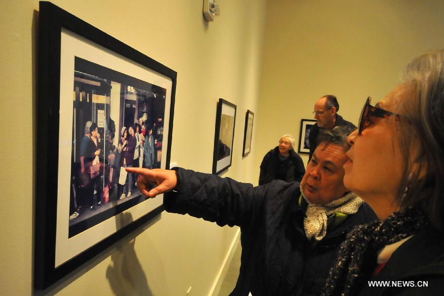 Audience visit the Images of Chinatown photo exhibition at Chinese Culture Center in San Francisco, the United States, Jan. 13, 2013.