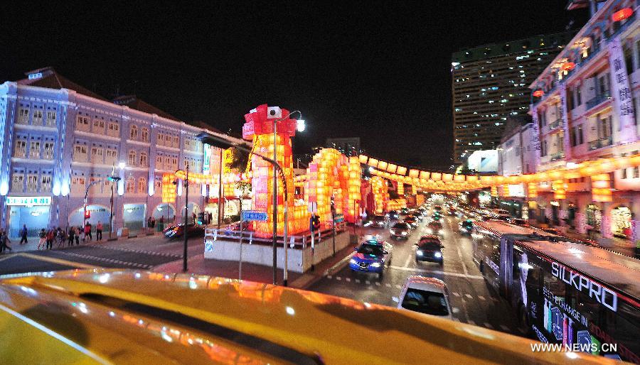 Picture taken on Jan. 15, 2013 shows a 128-meter-long snake-like red lantern between New Bridge Road and Eu Tong Sen Road in Singapore. The New Year lanterns lit up first time for preview on Tuesday.