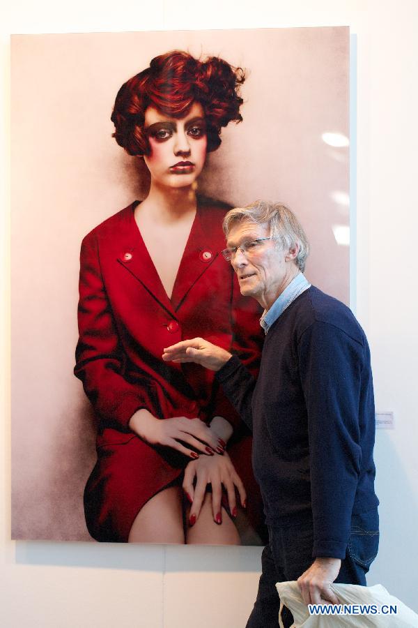 A visitor watches an art work at the 10th International 'REALISME' exhibition in Amsterdam, on Jan. 17, 2013. 