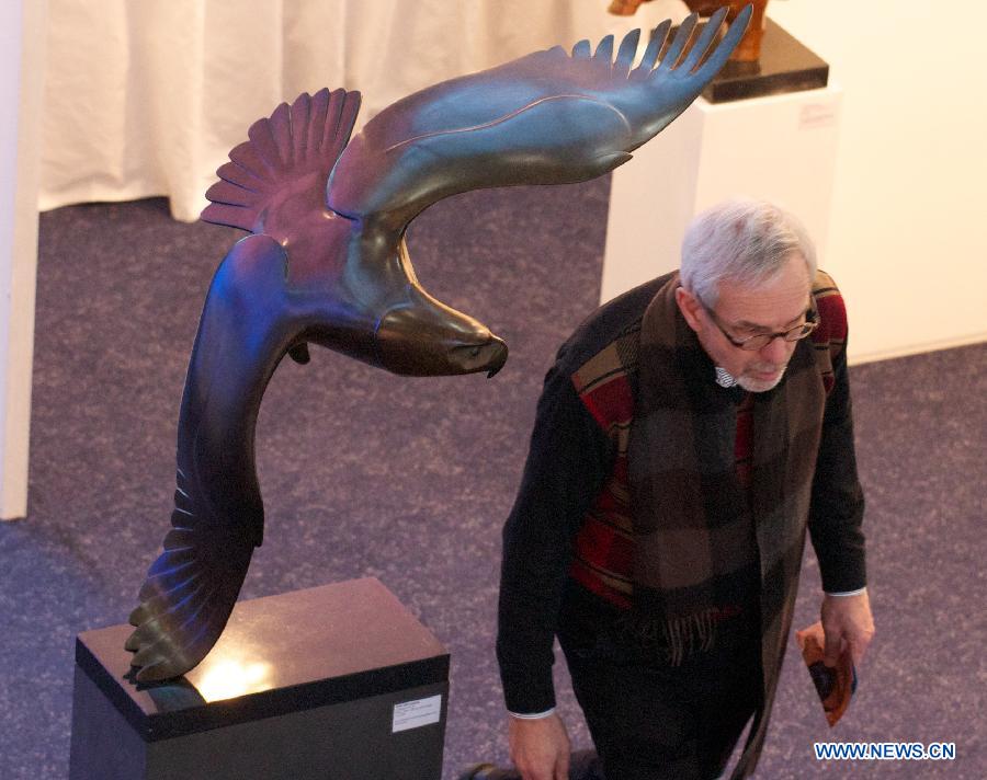A visitor watches an art work presented at the 10th International 'REALISME' exhibition in Amsterdam, on Jan. 17, 2013. 
