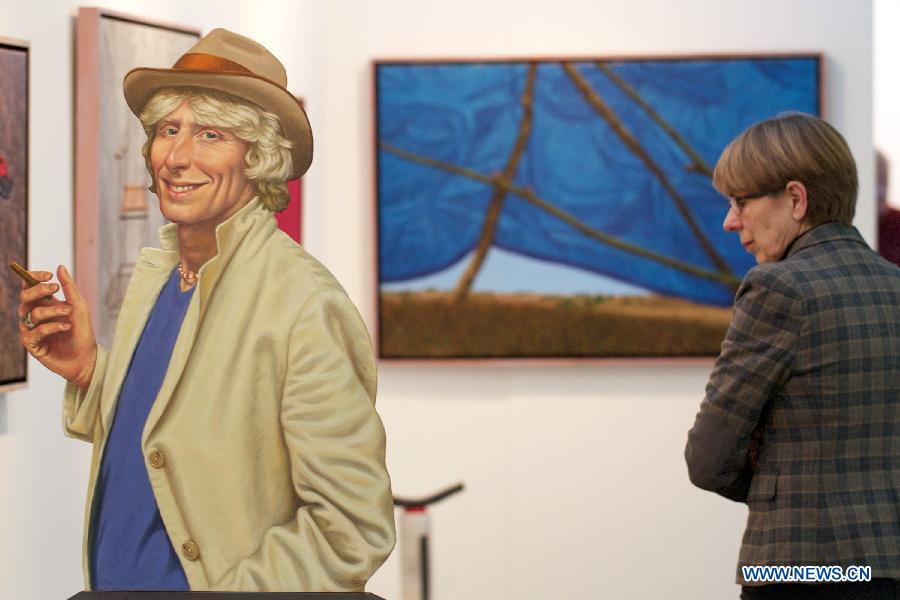 A visitor watches an art work presented at the 10th International 'REALISME' exhibition in Amsterdam, on Jan. 17, 2013. 