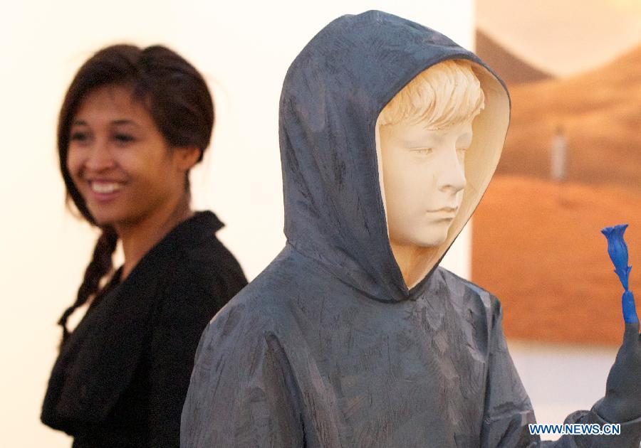 A visitor watches an art work presented at the 10th International 'REALISME' exhibition in Amsterdam, on Jan. 17, 2013. 