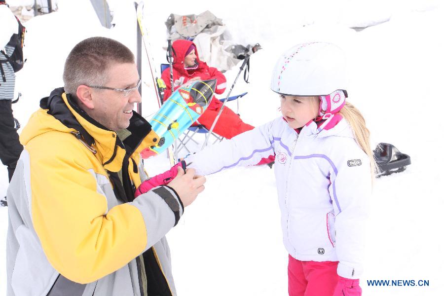 A father helps his daughter to prepare for skiing at skiing park in Mountain Jahorina near Sarajevo, Bosnia-Herzegovina, on Jan. 19, 2013