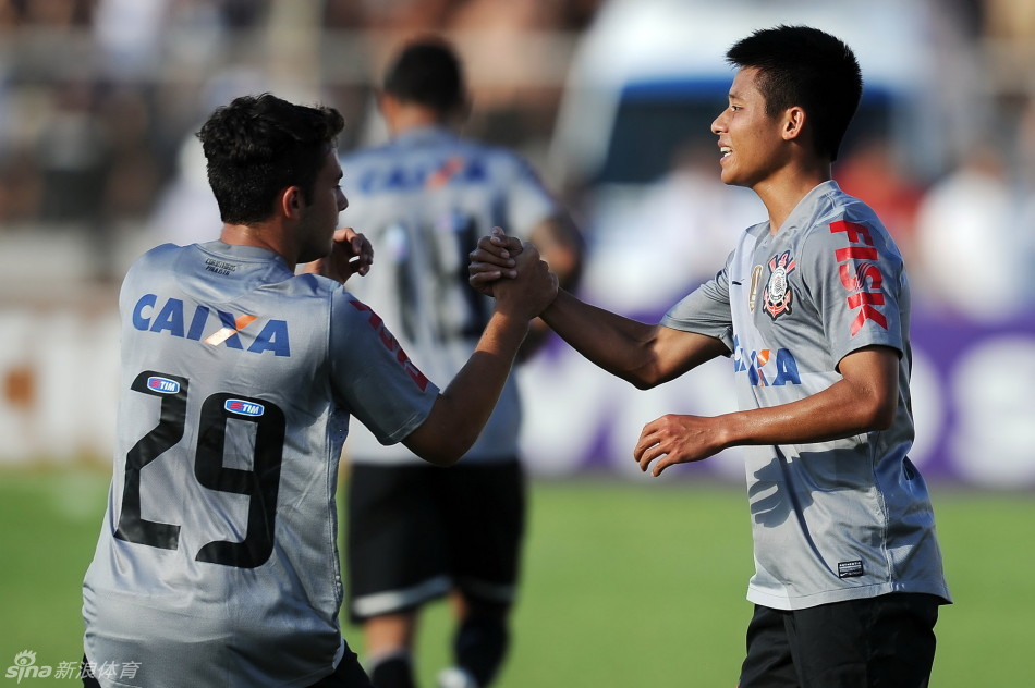 Chen celebrates with teammate after setting up the goal in his first start for Corinthians.