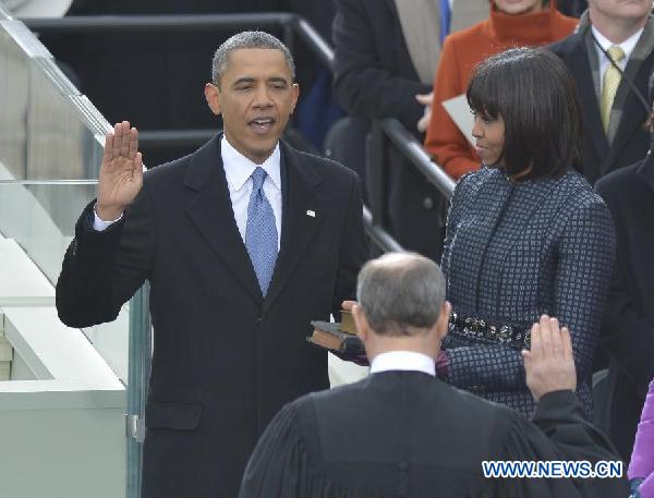 U.S. President Barack Obama (L) takes the oath of office during the presidential inauguration ceremony on the West Front of the U.S. Capitol in Washington D.C., the United States, on Jan. 21, 2013. [Xinhua] 