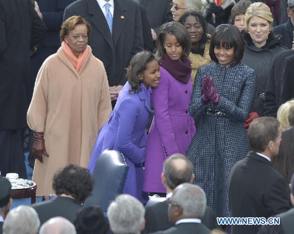 U.S. first lady Michelle Obama (C) and her two daughters attend the presidential inauguration ceremony on the West Front of the U.S. Capitol in Washington D.C., the United States, on Jan. 21, 2013 [Xinhua] 