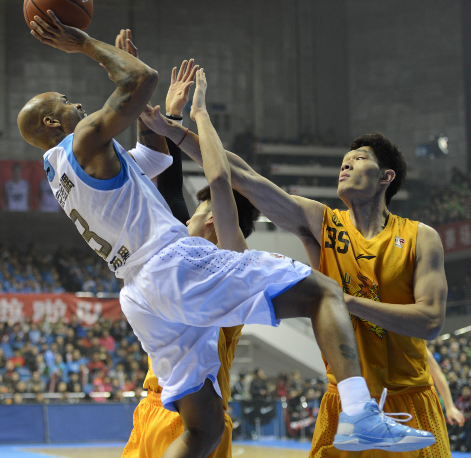 Stephon Marbury of Beijing shoots in front of defender in a CBA game between Beijing and Shanxi on Jan.23, 2013.