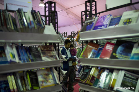 A man reads a book during the 44th Cairo International Book Fair in Cairo, Egypt, Jan. 23, 2013.