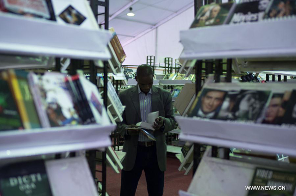 A man reads a book during the 44th Cairo International Book Fair in Cairo, Egypt, Jan. 23, 2013.