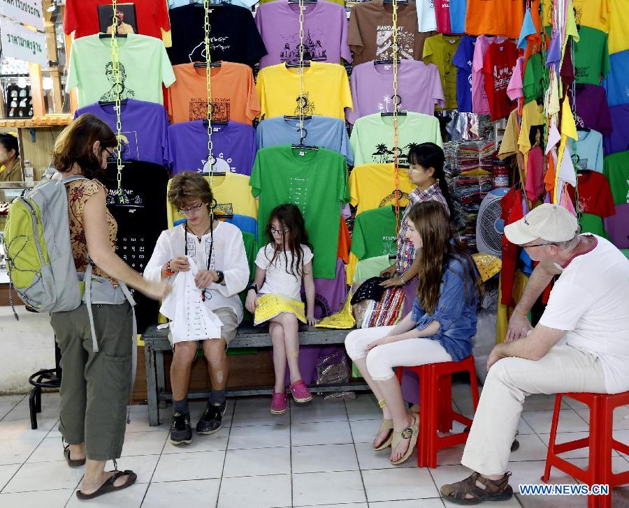 Tourists select clothes at a shop in Yangon, Myanmar, on Jan. 24, 2013. 