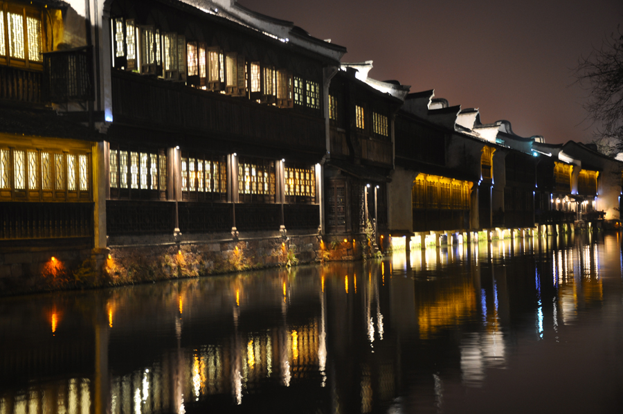 With a history of 1,200-years, Wuzhen is about one hour's drive from Hangzhou, the capital of Zhejiang province. The small town is famous for the ancient buildings and old town layout, where bridges of all sizes cross the streams winding through the town.[Photo by Yuan Fang/China.org.cn]