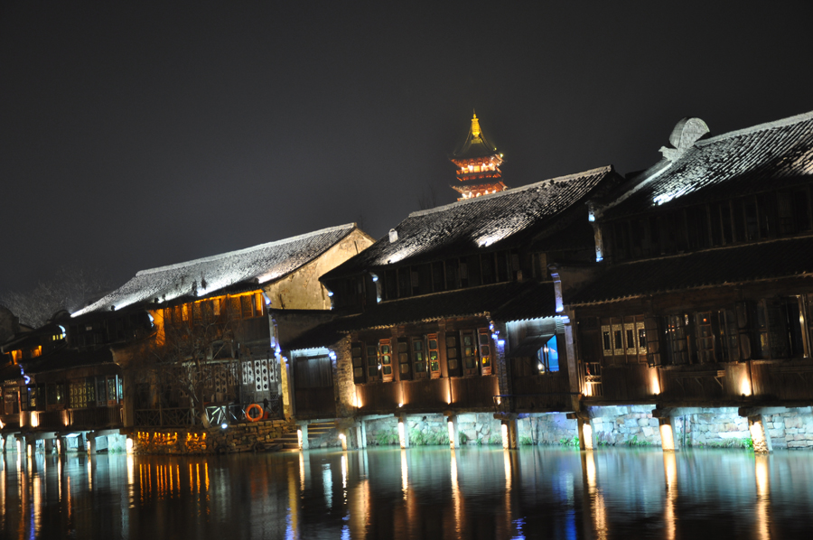 With a history of 1,200-years, Wuzhen is about one hour's drive from Hangzhou, the capital of Zhejiang province. The small town is famous for the ancient buildings and old town layout, where bridges of all sizes cross the streams winding through the town.[Photo by Yuan Fang/China.org.cn]