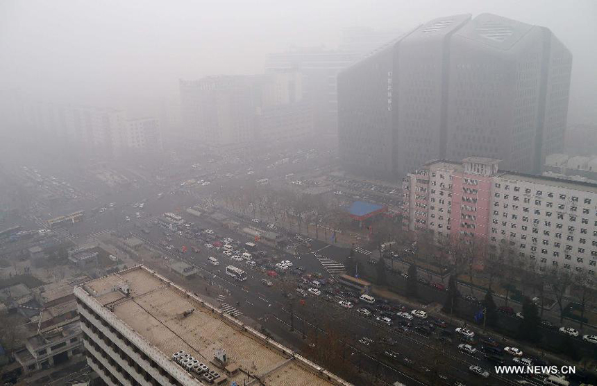 Heavy fog blankets the buildings in Beijing, capital of China, Jan. 29, 2013. The National Meteorological Center (NMC) issued a blue-coded alert on Jan. 29 as foggy weather forecast for the coming hours will cut visibility and worsen air pollution in some central and eastern Chinese cities. 