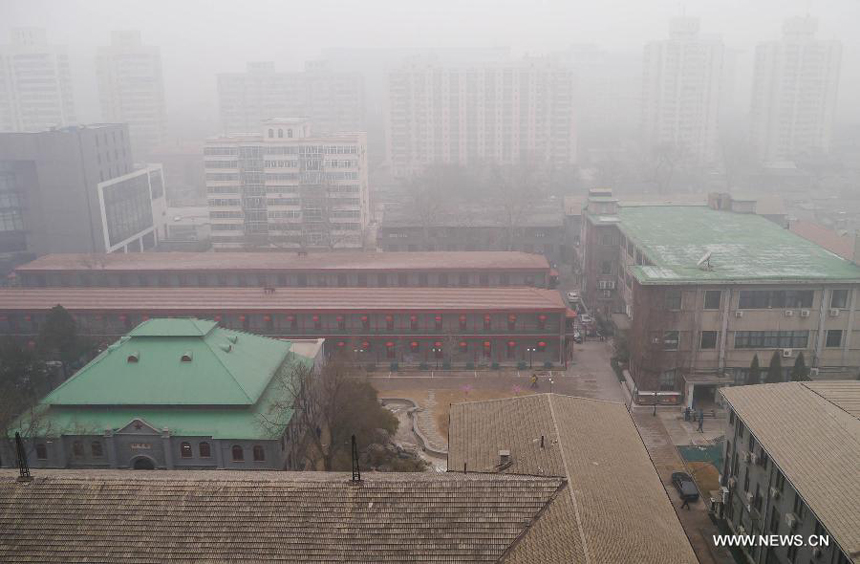 Heavy fog blankets the buildings in Beijing, capital of China, Jan. 29, 2013. The National Meteorological Center (NMC) issued a blue-coded alert on Jan. 29 as foggy weather forecast for the coming hours will cut visibility and worsen air pollution in some central and eastern Chinese cities. 