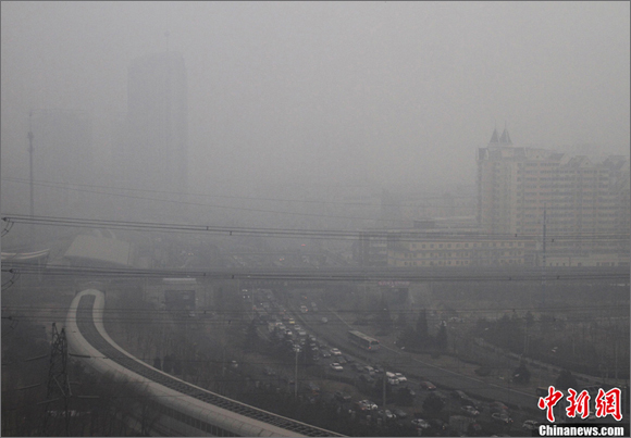 Heavy fog blankets the buildings in Beijing, capital of China, Jan. 29, 2013. 