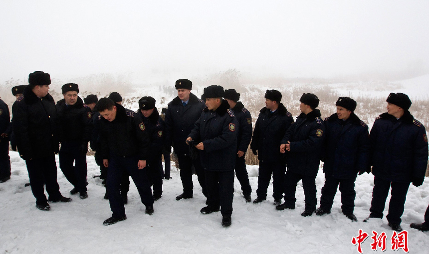 Photo taken by a witness shows people gathering at the site of the plane crash in Almaty, Kazakhstan, Jan. 29, 2013. A passenger plane flying from northern city of Kokshetau to Almaty crashed near Almaty airport Tuesday, killing all 20 people aboard.