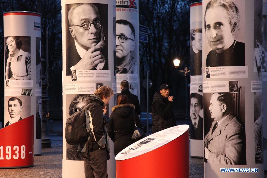 Visitors view the 'Diversity Destroyed, Berlin 1933, 1938, 1945' outdoor exhibition in Berlin, Germany, Jan. 29, 2013. 