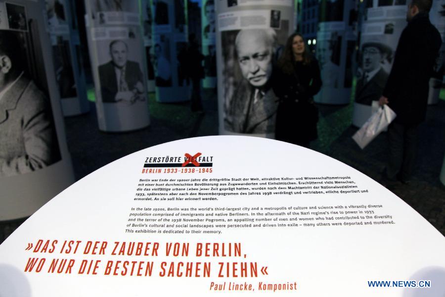 Visitors view the 'Diversity Destroyed, Berlin 1933, 1938, 1945' outdoor exhibition in Berlin, Germany, Jan. 29, 2013. 