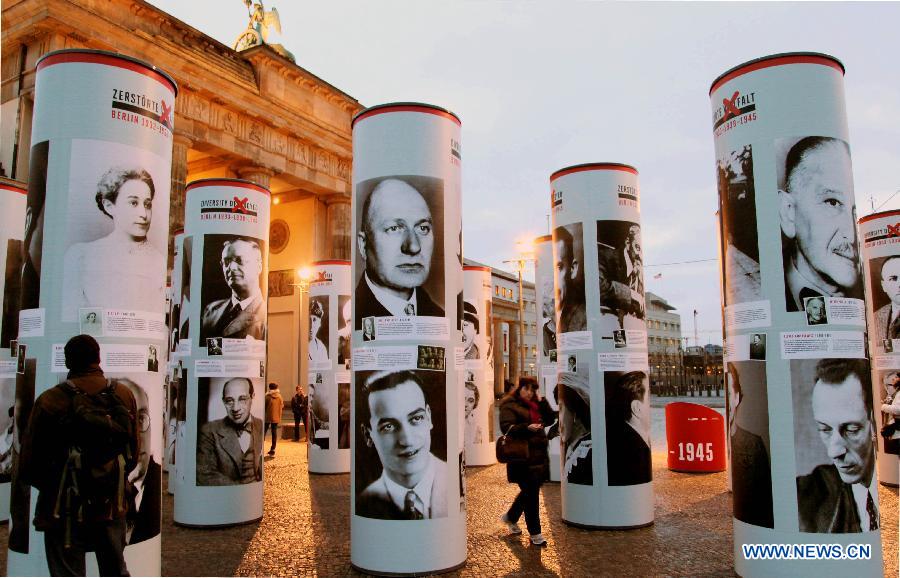 Visitors view the 'Diversity Destroyed, Berlin 1933, 1938, 1945' outdoor exhibition in Berlin, Germany, Jan. 29, 2013. 