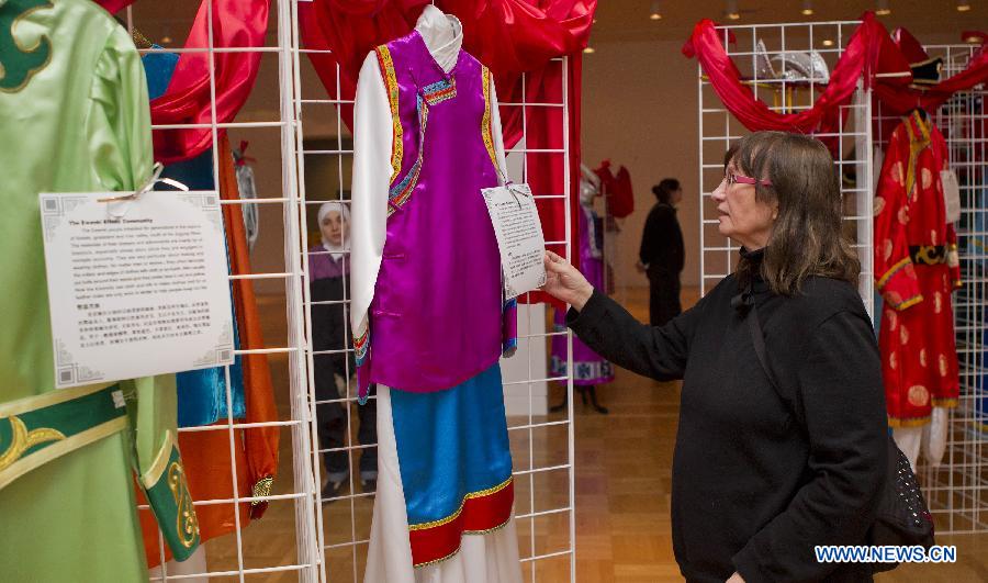 A visitor looks at costumes of China's Naxi ethnic group during the Chinese Cultural Heritage Day event at the Royal Ontario Museum in Toronto, Canada, Feb. 2, 2013.