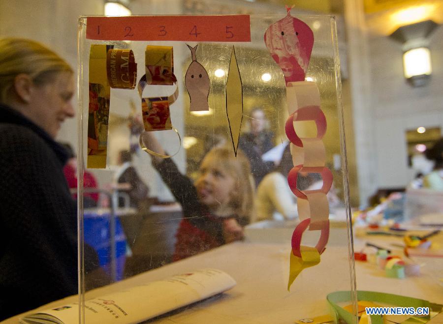 A girl learns to make a paper snake during the Chinese Cultural Heritage Day event at the Royal Ontario Museum in Toronto, Canada, Feb. 2, 2013. 