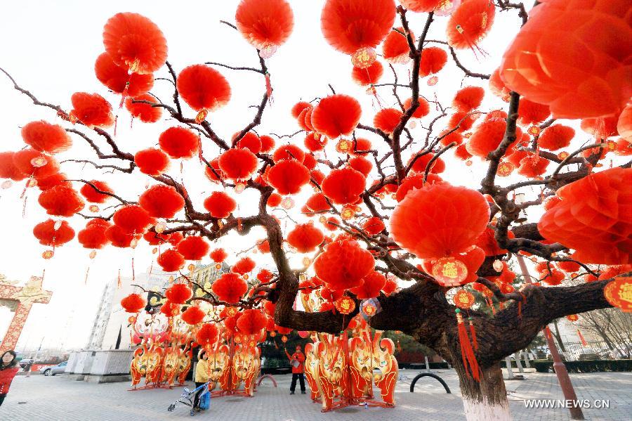Red lanterns are hanged on trees in the Temple of Earth Park in Beijing, capital of China, Feb. 2, 2013. The Temple of Earth Park was decorated with red lanterns so as to celebrate the upcoming Spring Festival or Chinese Lunar New Year.