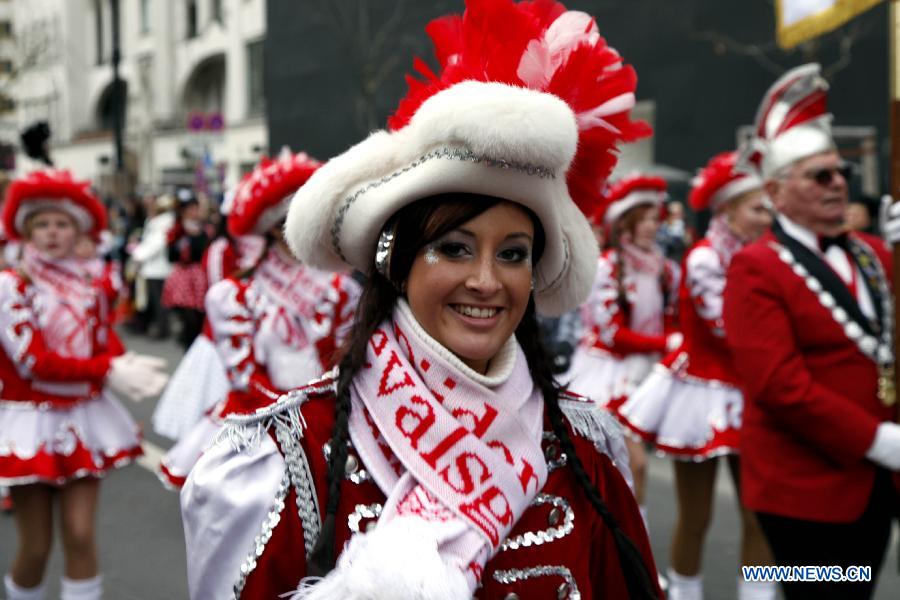 A girl in flamboyant costumes sings and dances during the grand procession of the 13th Berliner Fasching Parade in Berlin Feb. 3, 2013