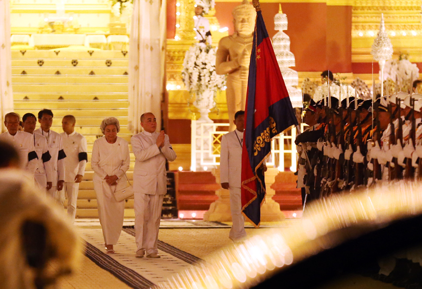 Sihanouk&apos;s wife Queen Mother Norodom Monineath (L-Central) and Cambodian King Norodom Sihamoni (R-Central) are seen at the custom-built funeral site where the body of the late Cambodian former King Norodom Sihanouk is placed, next to the Royal Palace in Phnom Penh, capital of Cambodia, on Feb. 3, 2013. The royal cremation ceremony of the late former Cambodian King Norodom Sihanouk will be held on Monday.