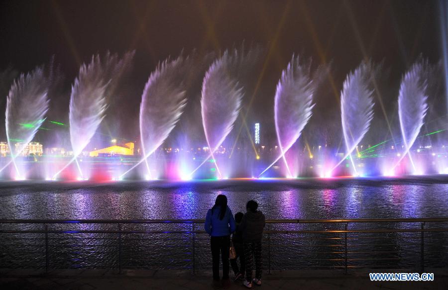 Visitors view the laser fountain during a lantern show in Changsha, capital of central China's Hunan Province, Feb. 5, 2013.