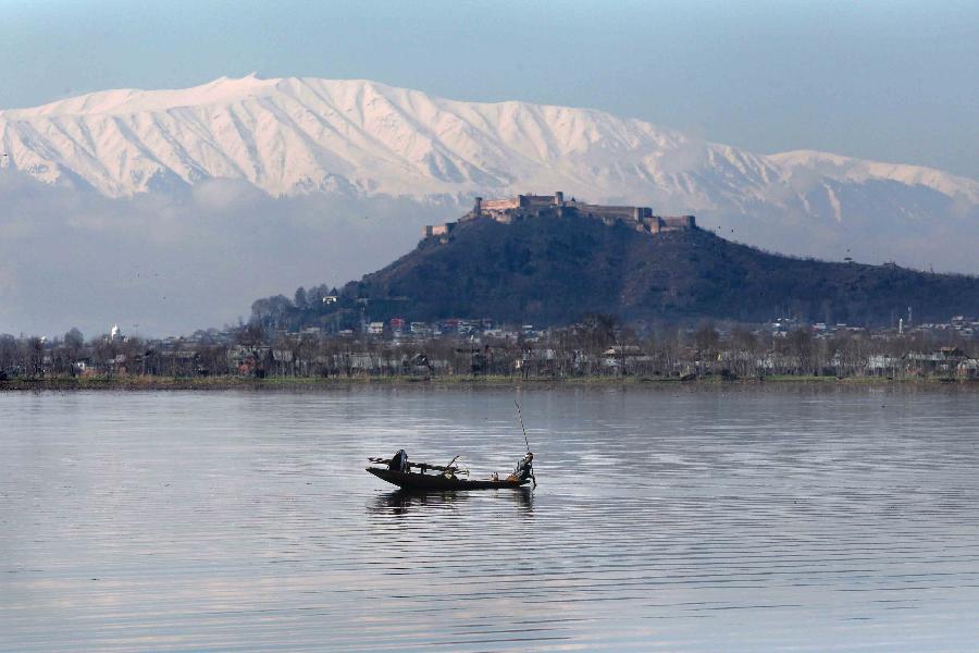 A Kashmiri man rows a boat on Dal Lake during a sunny day in Srinagar, summer capital of Indian-controlled Kashmir, Feb. 6, 2013.