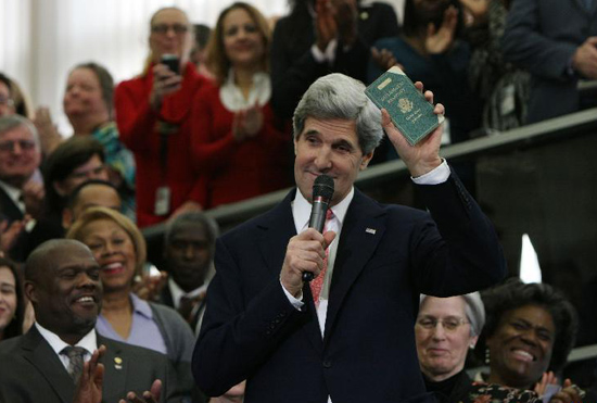 U.S. Secretary of State John Kerry shows his first diplomatic passport during the welcoming ceremony at the Department of State in Washington D.C. on Feb.4, 2013. John Kerry was sworn in on Feb 1 to succeed Hillary Clinton to become U.S. Secretary of State. [Xinhua/Fang Zhe]
