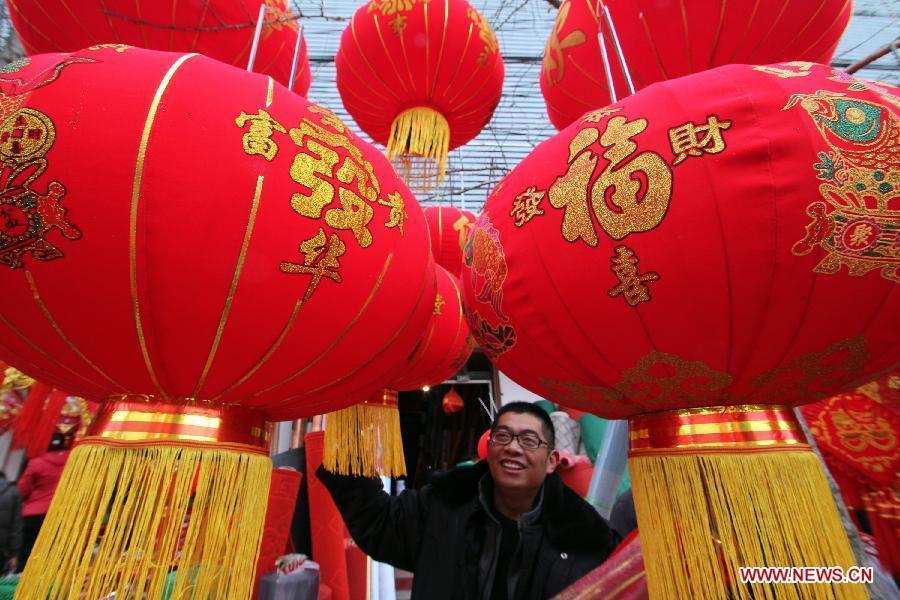 A man selects red lanterns for the coming Spring Festival in Linyi City, east China's Shandong Province, Feb. 8, 2013. The Spring Festival, the most important occasion for the family reunion for the Chinese people, falls on the first day of the first month of the traditional Chinese lunar calendar, or Feb. 10 this year. [Xinhua]