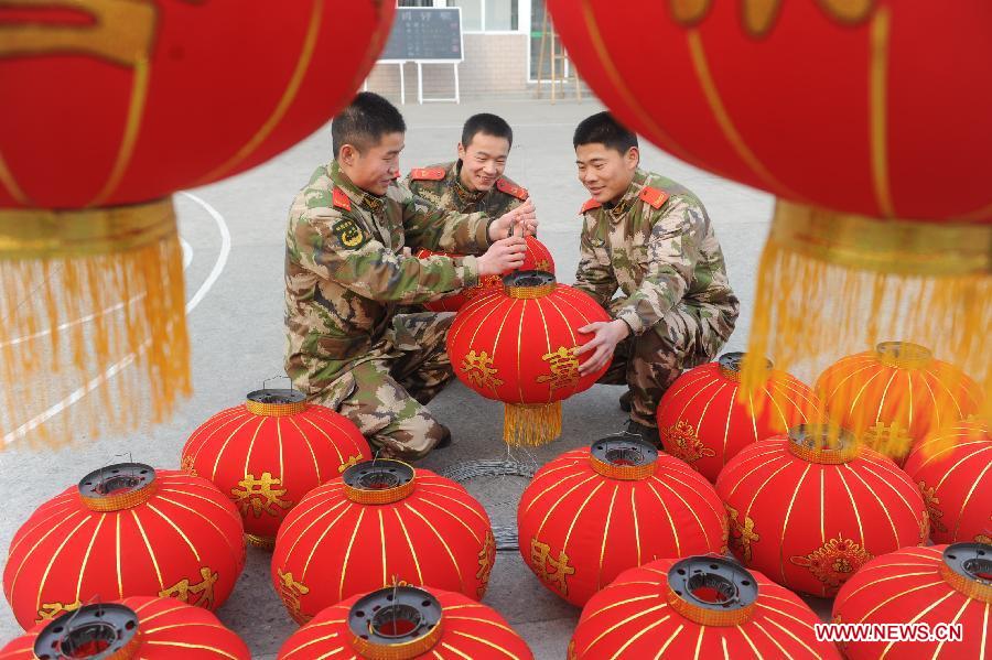 Soldiers prepare red lanterns to decorate their barrack for the coming Spring Festival in Fuyang City, east China's Anhui Province, Feb. 8, 2013. The Spring Festival, the most important occasion for the family reunion for the Chinese people, falls on the first day of the first month of the traditional Chinese lunar calendar, or Feb. 10 this year. [Xinhua]