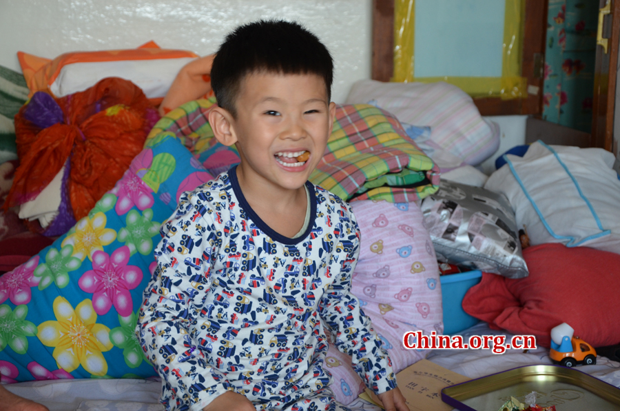  Sneaking in and out of the wardrobe in his grandpa's 15-square-meters house is Gao Yubo's favorite game. [By Gong Yingchun/China.org.cn]