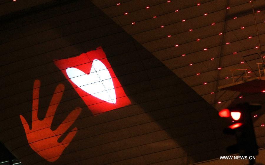 LED lights form shapes of hearts on the exterior wall of Palais des Congres (Conference Palace) on Saint Valentines's Day in Paris, France, Feb. 14, 2013. 