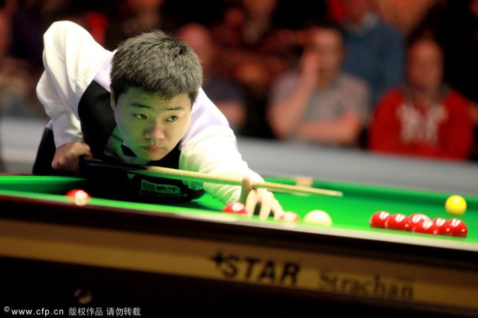 Ding Junhui of China hits a ball in the quarter-final of Welsh Open against Robert Milkins.