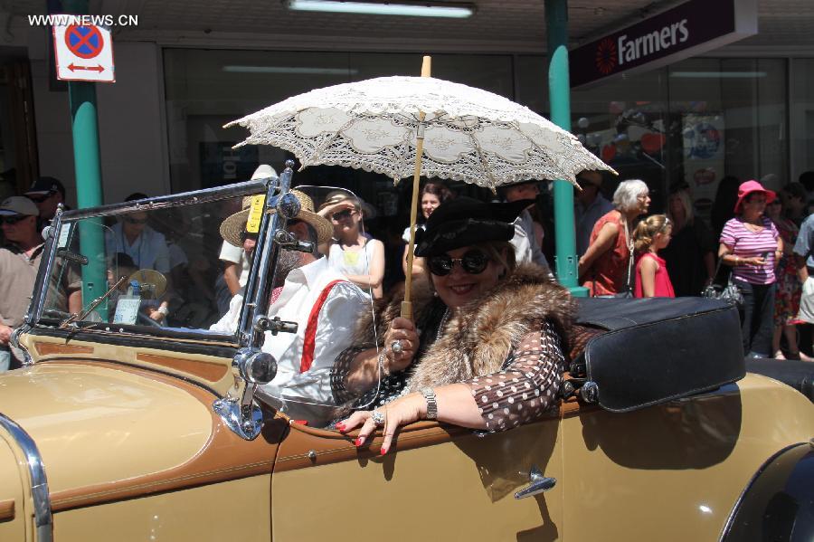 People drive a vintage car in the Vintage Car Parade in Napier, New Zealand, Feb. 16, 2013