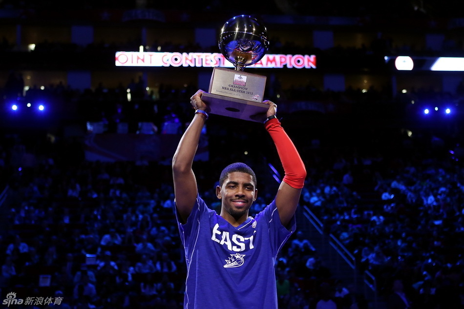 Cleveland Cavaliers guard Kyrie Irving is presented with the three-point contest trophy after the 2013 NBA three-point contest at the Toyota Center